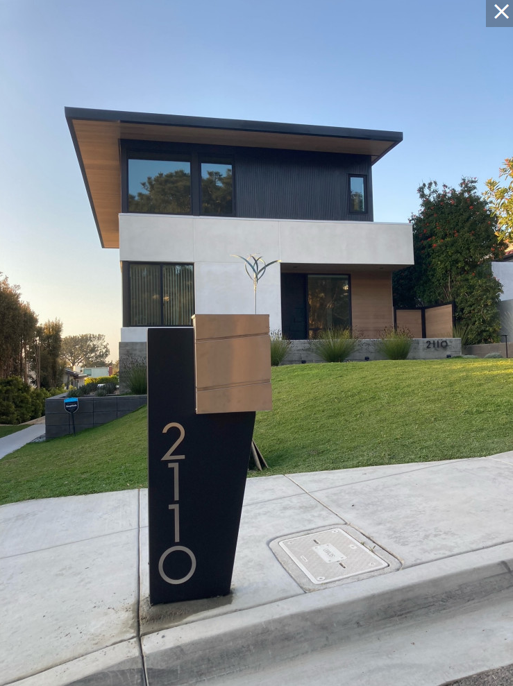 Modern Mailbox with Stand in front of Contemporary Home